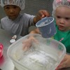 Preschoolers adding flour