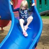 A Little Angel going down the slide